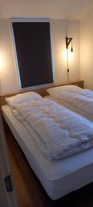 a bed in a bedroom with a large window at Rekerlanden 241 in Schoorldam