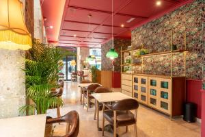 a restaurant with tables and chairs and plants at Boemio FLH Hotels in Lisbon