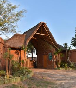 an old building with a thatched roof at Tipperary Game Lodge - Mbombela in Karino