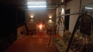 a living room with a fire in a brick wall at Dharti - The Glamping Haven by StayApart in Bijanbāri Bāzār