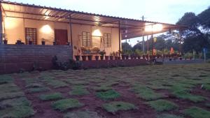 a house with a grass yard in front of it at Dharti - The Glamping Haven by StayApart in Bijanbāri Bāzār