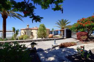 a house on the beach with palm trees at Finca Marina BuenVivir in Tazacorte