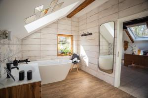 a bathroom with a white tub and a sink at Bled House Of Green in Bled