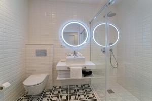 a white bathroom with a sink and a mirror at Morar Ourense in Ourense