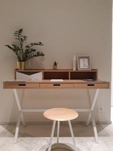 escritorio de madera con taburete y planta en Puhr House, 