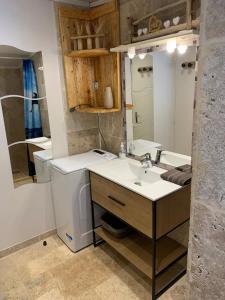 uma casa de banho com um lavatório e um espelho grande em Appartement FredMart em Mougins
