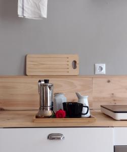 a kitchen counter with a coffee maker on a wooden shelf at CAN TANDO Restored catalan old barn to enjoy peaceful rural simplicity in Sant Jordi Desvalls