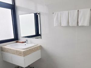 フーコックにあるHotel Phúc Lâm Grand Worldのバスルーム(洗面台、窓、タオル付)