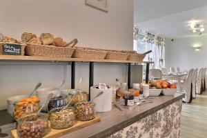 a buffet with bread and other foods on a table at Grand Hôtel des Bains SPA in Fouras