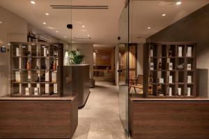 a wine store with a display case with wine bottles at Theros All Suite Hotel - Adults Only in Kos