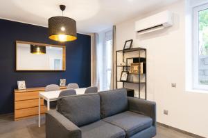 a living room with a couch and a table at LE 23 in Jarny