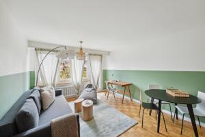 a living room with a couch and a table at Central Lucerne Apartments in Lucerne