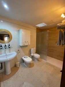 a bathroom with a sink and a toilet and a shower at Barri Antic Cambrils in Cambrils