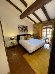 a bedroom with a large bed and a table at Barri Antic Cambrils in Cambrils