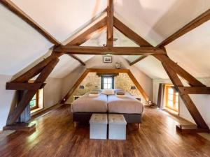 a bedroom with a large bed in a attic at Domaine des Grands Bois Privatisé in Sergeac