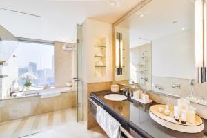 a bathroom with a sink and a large mirror at Address Dubai Marina Residences by Qstay in Dubai