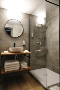 a bathroom with a sink and a shower at Alaïa Lodge in Crans-Montana