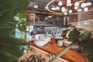 a living room with couches and a bar at Aedenlife Hotel & Resort Rügen in Trent