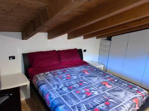 ein Schlafzimmer mit einem Bett mit einer Decke darauf in der Unterkunft Aria Fresca in Sovere