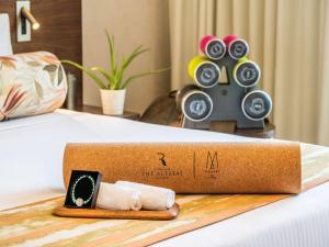 a cardboard box on a bed with a speaker at The Retreat Palm Dubai MGallery by Sofitel in Dubai