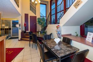 a dining room with a table and chairs at Econolodge Edson in Edson