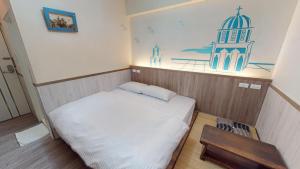 a small room with a bed and a table at Love Feng Jia Apartment Hotel in Taichung