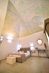 a bedroom with a bed and a painting on the ceiling at L'Antica Rimessa Da Gigi in Gallipoli