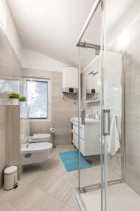a bathroom with a shower and a toilet and a sink at Apartments Croatia in Trogir