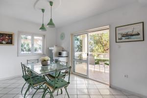 a dining room with a glass table and chairs at Apartments Croatia in Trogir