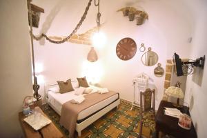 a bedroom with a bed and a clock on the wall at L'Antica Rimessa Da Gigi in Gallipoli