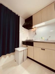 a small kitchen with a sink and a toilet at （B10）NEW OPEN アクセス良好！リフォーム完了☆サービスアパ―トメントSAPPORO南8条B10 in Ōdōri