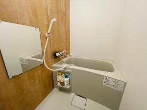 a bathroom with a sink and a mirror at （B10）NEW OPEN アクセス良好！リフォーム完了☆サービスアパ―トメントSAPPORO南8条B10 in Ōdōri