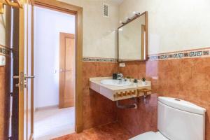 La salle de bains est pourvue d'un lavabo, d'un miroir et de toilettes. dans l'établissement Piso 3 habitaciones plaza de garaje privada y gratuita, à Almería