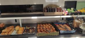a bakery with many different types of bread and pastries at Contact Hôtel Arc-En-Ciel - Réouverture - Rénové in Mulhouse