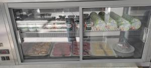 a refrigerator filled with lots of food and drinks at Contact Hôtel Arc-En-Ciel - Réouverture - Rénové in Mulhouse +13 photos