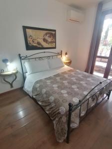 a bedroom with a bed with a bedspread on it at SelfMatic in Orio al Serio