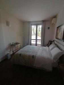 a bedroom with a large bed and a window at SelfMatic in Orio al Serio