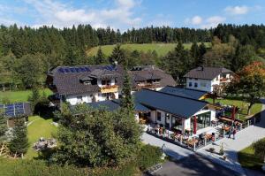an aerial view of a house with solar panels on it at Landhotel Kleblmühle in Grafenau