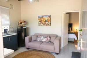 a living room with a couch and a bedroom at The Lemon Tree in Ceres