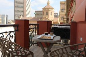 a table with a tray of donuts on a balcony at New Midtown in Cairo