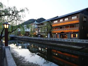 a street light next to a river with buildings at Ichidaya in Toyooka