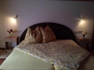 a bedroom with a large bed with two night stands at Ferienwohnung Anita Bernhardt in Rimbach