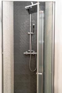a shower in a bathroom with a glass door at York City House in York