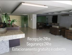 a large room with a living room with a table at Life Tabatinga Beach-Flat com Wi-Fi in Conde