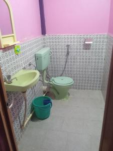 a bathroom with a toilet and a sink at Shalom guest house in Cherrapunji