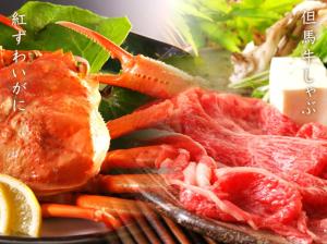 a plate of food with meat and vegetables on a table at Ichidaya in Toyooka
