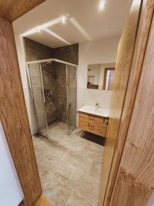łazienka z prysznicem i umywalką w obiekcie Appartement Waldplatzl w mieście Altenmarkt im Pongau