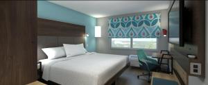 Tempat tidur dalam kamar di Tru By Hilton Wilmington