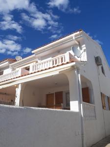 a white house with a fence in front of it at Casa Elisa 3 bedrooms 2 bathrooms 4 airco's shared pool in Alcossebre