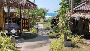 a resort with the ocean in the background at Lazy Days Bungalows in Ko Lanta